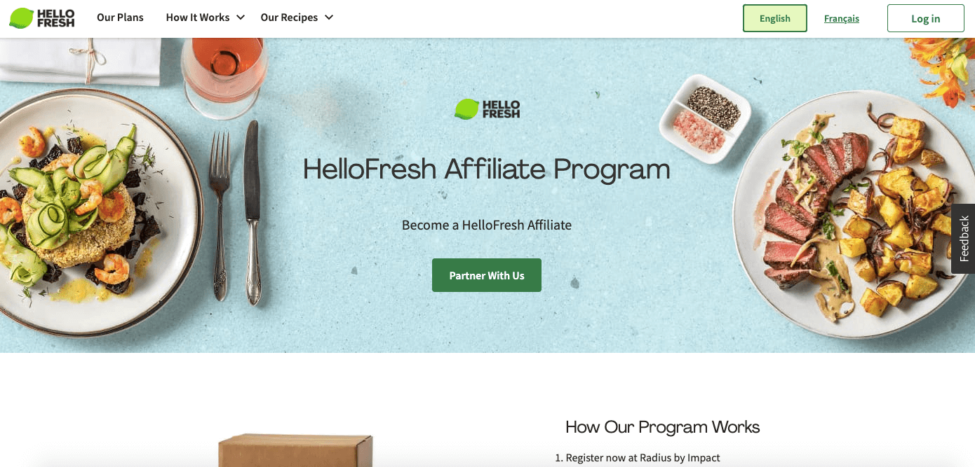 HelloFresh is a meal delivery service that offers a great affiliate program for bloggers and content creators in the food niche. Screenshot of the “HelloFresh Affiliate Program,” featuring a few gourmet dishes, drinks, and spices on a blue table.
