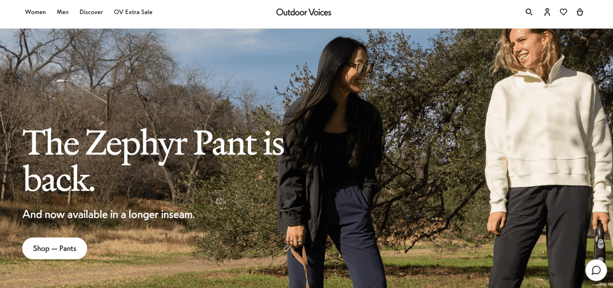 The image displays the homepage of Outdoor Voices stating they have Zephyr Pants back in stock with an image of two women walking outside on a cool afternoon.