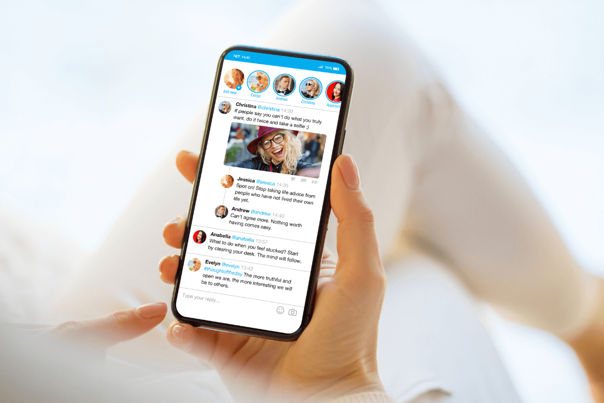 You don’t need a massive following to start earning with affiliate marketing on Twitter. The photo shows someone holding a smartphone with an app open like Twitter. The person is viewing a feed of users as they comment on a picture of a woman smiling. Underneath the image are two replies complimenting the photo and caption.