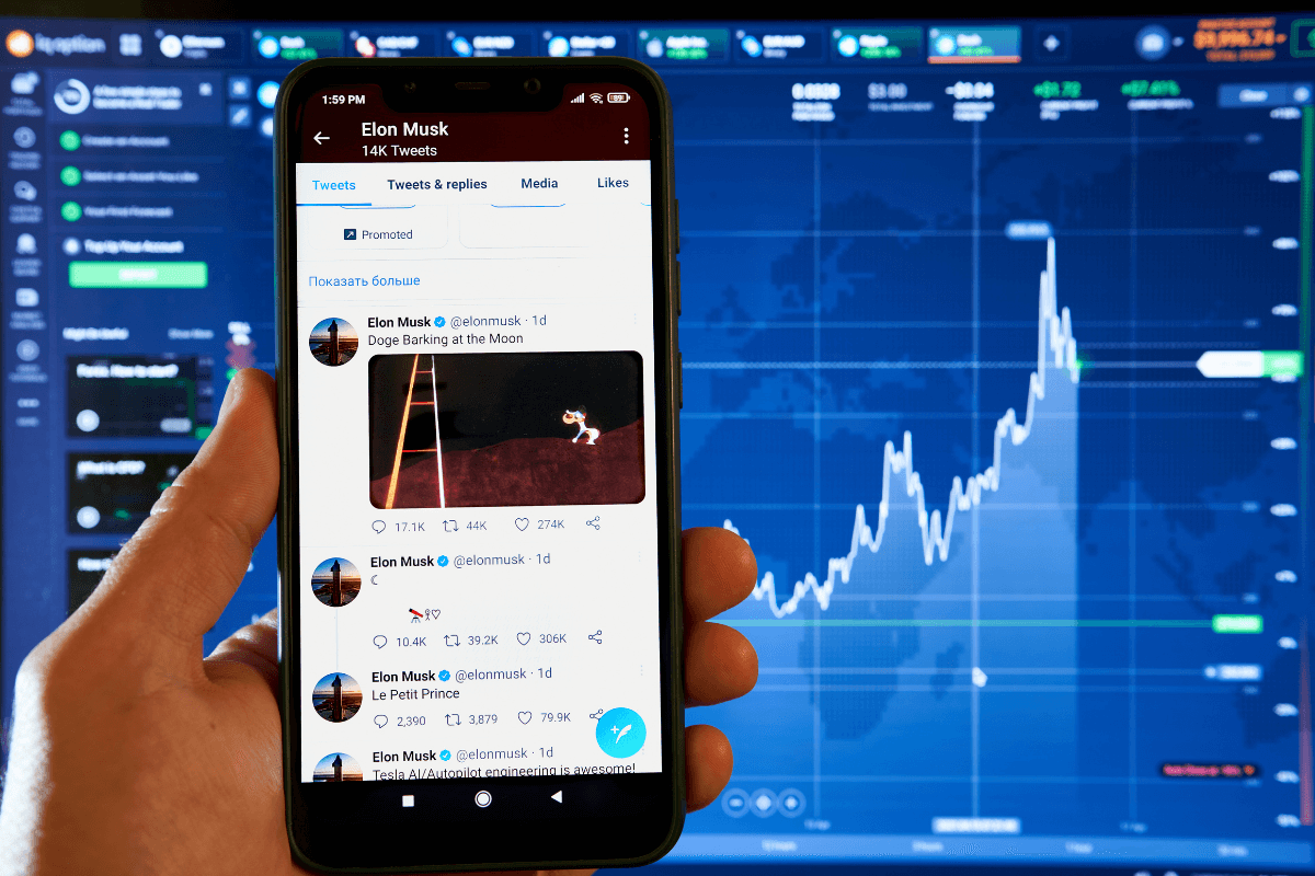Use these tips for effective affiliate marketing on Twitter. The image shows someone holding a phone and looking at Tweets from Elon Musk. Behind the phone is a web interface displaying analytics, with a bar graph showing growth trajectory.